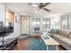Living room with L-shaped sofa and wood-look floors at 17200 W Bell Rd # 439, Surprise, AZ 85374