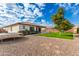 Large backyard with grassy area, gravel, and playground equipment at 18346 W Coolidge St, Goodyear, AZ 85395
