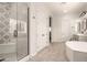 Elegant bathroom with soaking tub, walk-in shower, and double vanity at 18346 W Coolidge St, Goodyear, AZ 85395