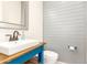 Bathroom with blue vanity, shiplap walls, and white sink at 18346 W Coolidge St, Goodyear, AZ 85395