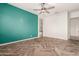 Bedroom featuring herringbone floors and teal accent wall at 18346 W Coolidge St, Goodyear, AZ 85395