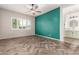 Bedroom with herringbone floors and teal accent wall at 18346 W Coolidge St, Goodyear, AZ 85395
