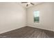 Bright bedroom featuring dark laminate flooring and a window with blinds at 18346 W Coolidge St, Goodyear, AZ 85395