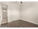 Simple bedroom with dark laminate wood flooring and a closet at 18346 W Coolidge St, Goodyear, AZ 85395