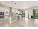Open kitchen with island, double ovens, and stylish backsplash at 18346 W Coolidge St, Goodyear, AZ 85395