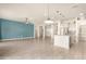 Modern kitchen with white cabinets, a large island, and pendant lighting at 18346 W Coolidge St, Goodyear, AZ 85395