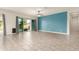 Living room with tile floors, sliding doors to patio, and blue accent wall at 18346 W Coolidge St, Goodyear, AZ 85395