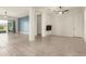 Spacious living area with tile floors, ceiling fan, and access to backyard at 18346 W Coolidge St, Goodyear, AZ 85395