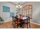 Bright dining room with a wooden table, chandelier, and decorative wall art at 1882 W Canary Way, Chandler, AZ 85286