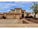 Two-story house with tan exterior, two-car garage, and landscaped front yard at 1882 W Canary Way, Chandler, AZ 85286