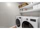 Bright laundry room features washer, dryer, and ample shelving at 1882 W Canary Way, Chandler, AZ 85286