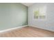 Bedroom with light green walls and wood floors at 2004 E Brigadier Dr, Gilbert, AZ 85298