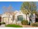 One-story house with a two-car garage and nicely landscaped yard with trees at 2004 E Brigadier Dr, Gilbert, AZ 85298