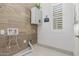 Laundry room with wood-look walls and white cabinets at 2004 E Brigadier Dr, Gilbert, AZ 85298