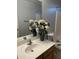 Bathroom with sink, large mirror, and fresh flowers at 2049 N Arbor Ln, Chandler, AZ 85225