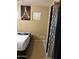 Well-lit bedroom with a full-size bed and Eiffel Tower art at 2049 N Arbor Ln, Chandler, AZ 85225