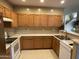 Galley kitchen with wood cabinets and stainless steel appliances at 2049 N Arbor Ln, Chandler, AZ 85225