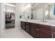 Double vanity bathroom with walk in shower and closet at 20771 W Windsor Blvd, Buckeye, AZ 85396