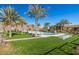 Inviting community pool surrounded by lush landscaping and palm trees at 20771 W Windsor Blvd, Buckeye, AZ 85396