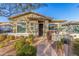 Single-story home with green siding, brick accents, and landscaped front yard at 20771 W Windsor Blvd, Buckeye, AZ 85396