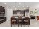 Island kitchen with dark cabinets and stainless steel appliances at 20771 W Windsor Blvd, Buckeye, AZ 85396