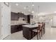 Spacious kitchen with dark cabinetry, quartz countertops, and an island at 20771 W Windsor Blvd, Buckeye, AZ 85396
