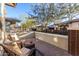 Cozy patio with wicker chairs and a small table, overlooking a community yard at 20771 W Windsor Blvd, Buckeye, AZ 85396