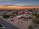 Aerial view of a single-story home at sunset with city views at 20918 E Orchard Ln, Queen Creek, AZ 85142