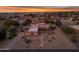 Aerial sunset view of a single-story home with a large backyard at 20918 E Orchard Ln, Queen Creek, AZ 85142