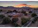 Aerial view of a single story home with large backyard at sunset at 20918 E Orchard Ln, Queen Creek, AZ 85142