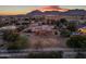 Aerial view of a beautiful home with a pool and large backyard, set against a mountain backdrop at 20918 E Orchard Ln, Queen Creek, AZ 85142