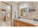 Single vanity bathroom with decorative mirror and shelving at 20918 E Orchard Ln, Queen Creek, AZ 85142