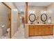 Double vanity with ample storage and decorative mirrors at 20918 E Orchard Ln, Queen Creek, AZ 85142