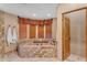 Relax in this spa-like bathroom, featuring a large soaking tub and tile shower at 20918 E Orchard Ln, Queen Creek, AZ 85142