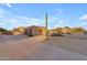 View of a beautiful home with a long driveway and desert landscaping at 20918 E Orchard Ln, Queen Creek, AZ 85142