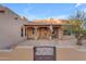 Front entrance with a covered porch, decorative gate, and a stone pathway at 20918 E Orchard Ln, Queen Creek, AZ 85142