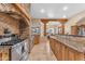 Kitchen with island, granite countertops, and wood cabinets at 20918 E Orchard Ln, Queen Creek, AZ 85142