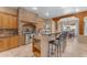 Open kitchen with stainless steel appliances and a stone-faced range hood at 20918 E Orchard Ln, Queen Creek, AZ 85142