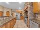 Kitchen boasts stainless steel appliances and wood cabinetry at 20918 E Orchard Ln, Queen Creek, AZ 85142