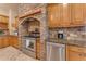 Kitchen with stone range hood and stainless steel appliances at 20918 E Orchard Ln, Queen Creek, AZ 85142