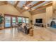 Spacious living room with high ceilings, a fireplace, and large windows at 20918 E Orchard Ln, Queen Creek, AZ 85142