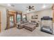 Living room with sectional sofa and treadmill at 20918 E Orchard Ln, Queen Creek, AZ 85142