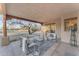 Relaxing covered patio with seating area and views of the backyard at 20918 E Orchard Ln, Queen Creek, AZ 85142