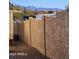Tan stucco wall encloses backyard; mountain view beyond at 2233 E Behrend Dr # 197, Phoenix, AZ 85024