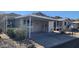 Mobile home exterior with carport and desert landscaping at 2233 E Behrend Dr # 197, Phoenix, AZ 85024