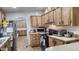View of kitchen with stainless steel appliances and wood cabinets at 2233 E Behrend Dr # 197, Phoenix, AZ 85024