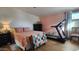 Main bedroom with coral walls, walk-in closet and treadmill at 2233 E Behrend Dr # 197, Phoenix, AZ 85024