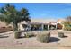 Landscaped backyard with desert plants and a patio area at 22619 N Las Lomas Ln, Sun City West, AZ 85375