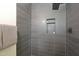 Modern shower with dark gray tile and built-in shelving at 2319 E Earll Dr, Phoenix, AZ 85016