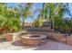 Relaxing backyard firepit with stone seating and landscaping at 2415 W Desperado Way, Phoenix, AZ 85085